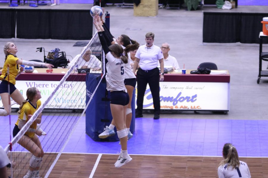 With their hands above the net, sophomore Saida Jacobs and freshman Ella Florez block the ball.