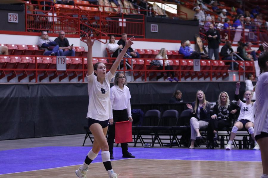 Celebrating a point, junior Kaitlyn Burke throws her hands in the air.
