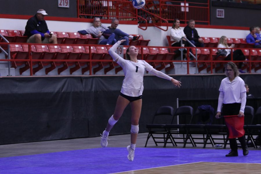 Keeping her eye on the ball, senior Madeline Shnepf prepares to serve the ball.