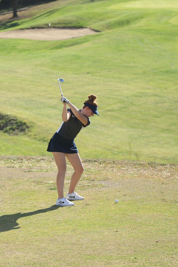 With a big swing, Freshman Sophie VanInwegen tees off.