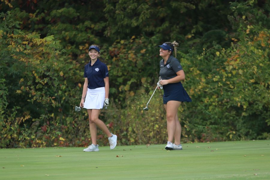 Smiling, junior Kathryn Yockey and sophomore Reagan Swartz laugh it out after driving into the hole. 