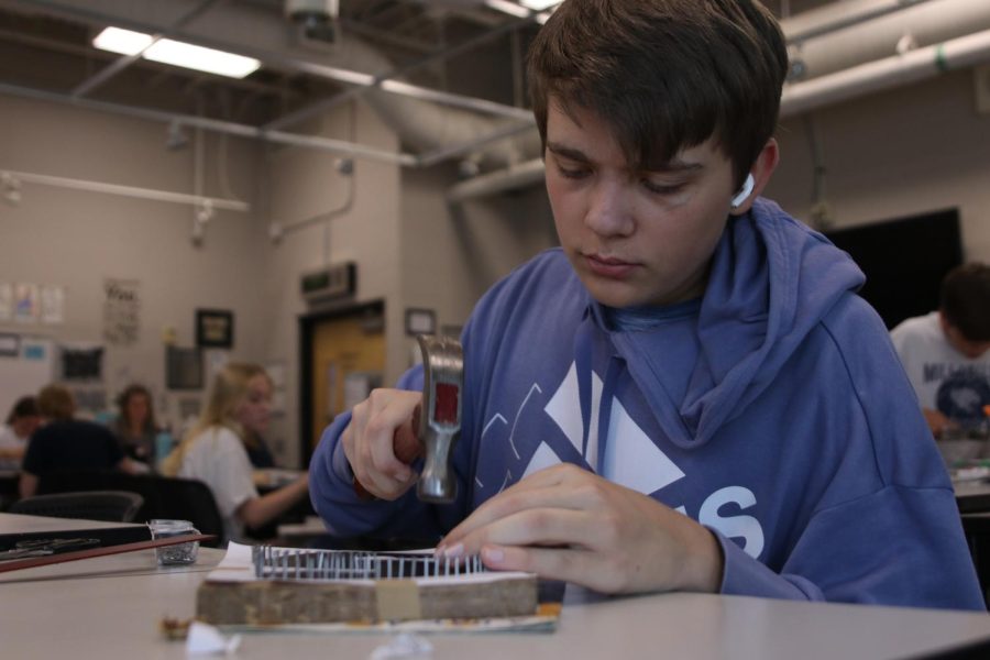 Junior Shai Kalthoff hammers nails into wood for his project Sept. 16 in Jodie Ellis’s survey of fine crafts class.
