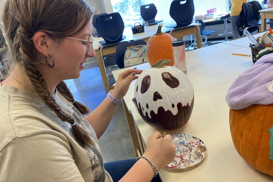 Freshman Liberty Bouskill finishes up her festive pumpkin. 