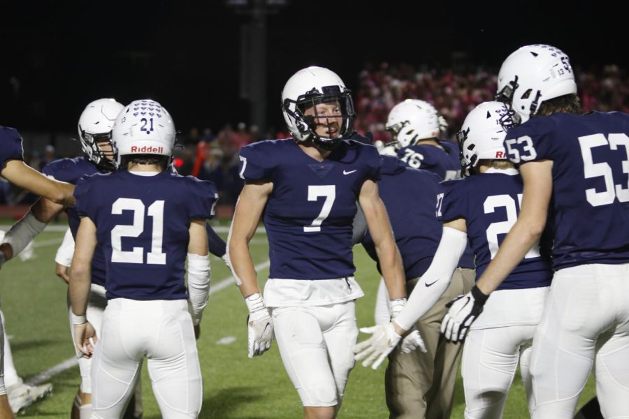 After an important stop from the defense, senior Mikey Bergeron high fives his teammates. 