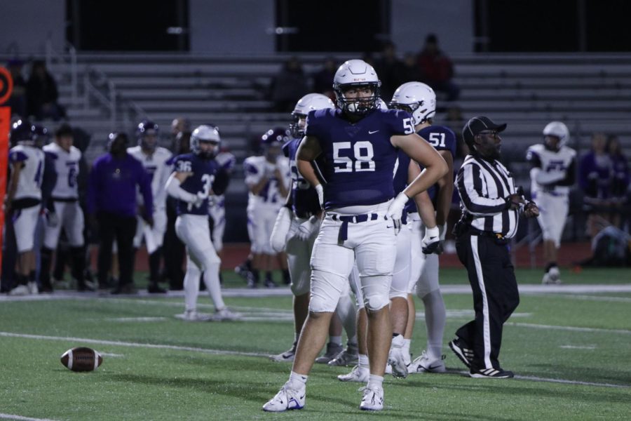 Sophomore Abe Shaffer looks towards the sideline for the next play call.