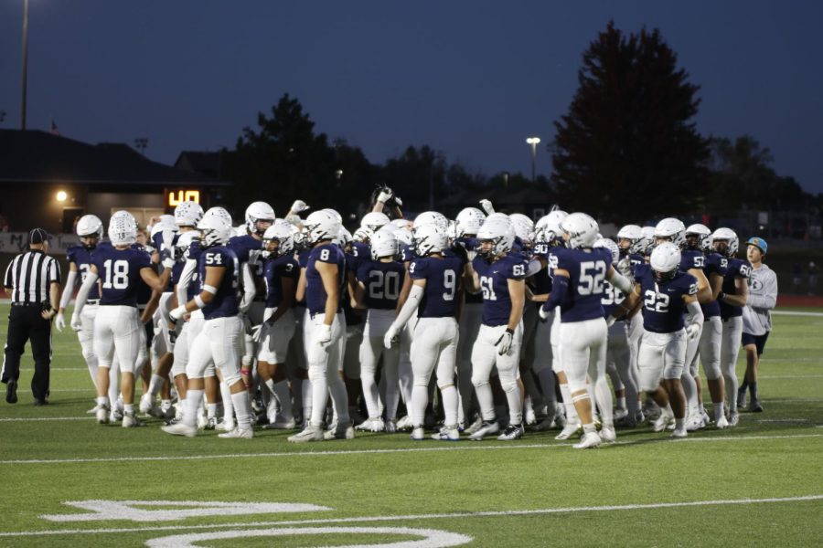 In the pregame huddle, the team prepares for kickoff.