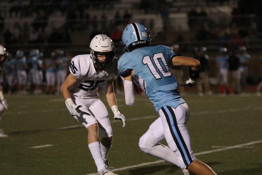 Running down the field, senior Hudson Ivey covers a receiver.
