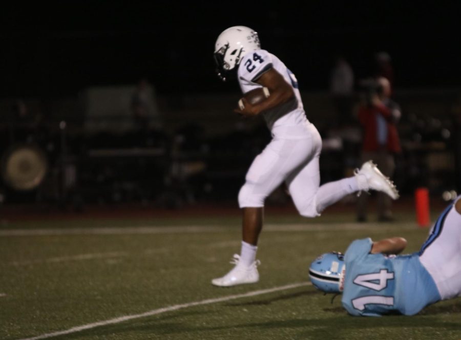 Running to the endzone, senior Amarian Graves gets away from a Shawnee Mission East player.