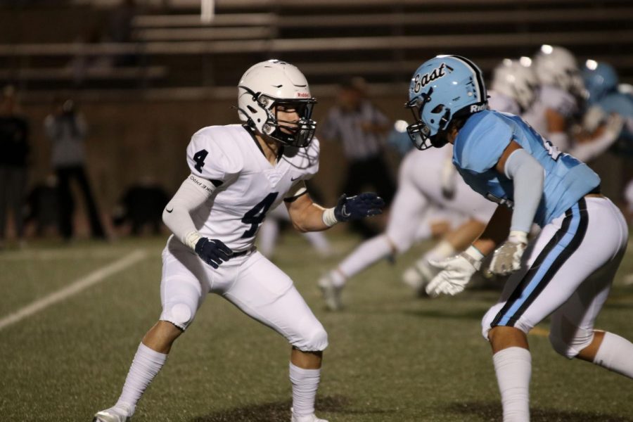 Prepared for the tackle, sophomore Aiden Harb tries to block the opponent.  