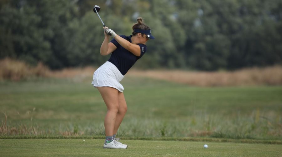 Driver in hand, junior Kathryn Yockey takes a practice swing before teeing off.