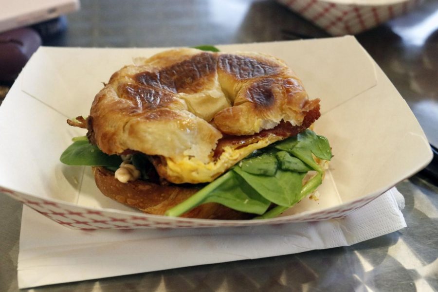 Offered all day, the specialty House Breakfast Sandwich is served on a croissant with either bacon or sausage, paired with a fried egg, fresh spinach, sun dried tomatoes, and spicy mayonnaise. 