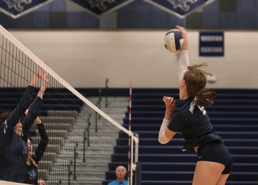 Sophomore Saida Jacobs reaches high for a kill against Olathe West. 
 