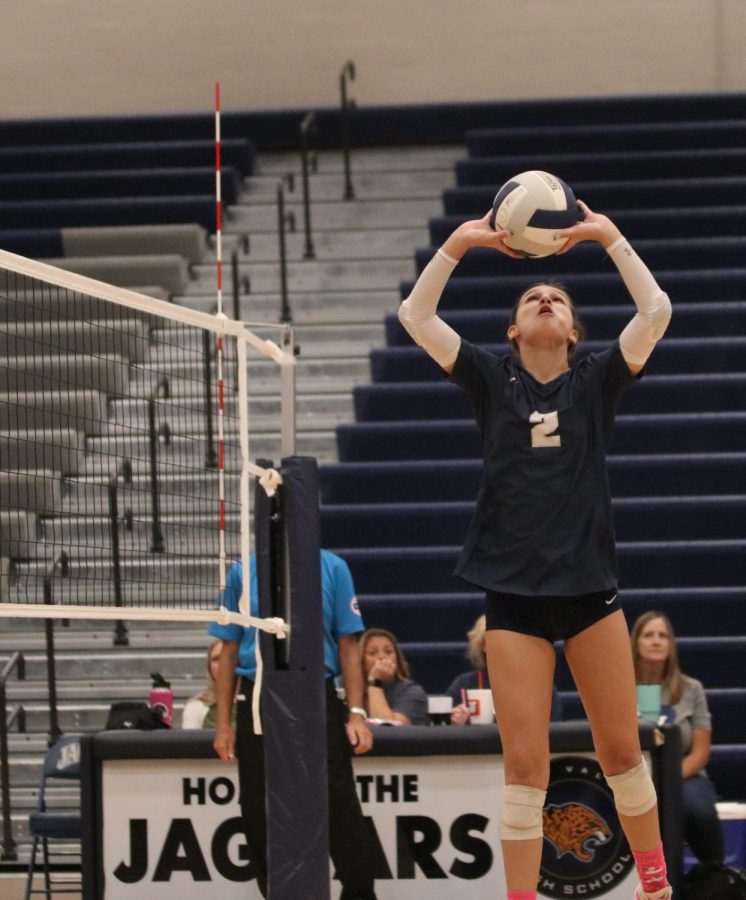 Arms up, junior Ava Jones focuses on her hands for the perfect set to her outside hitter. 

