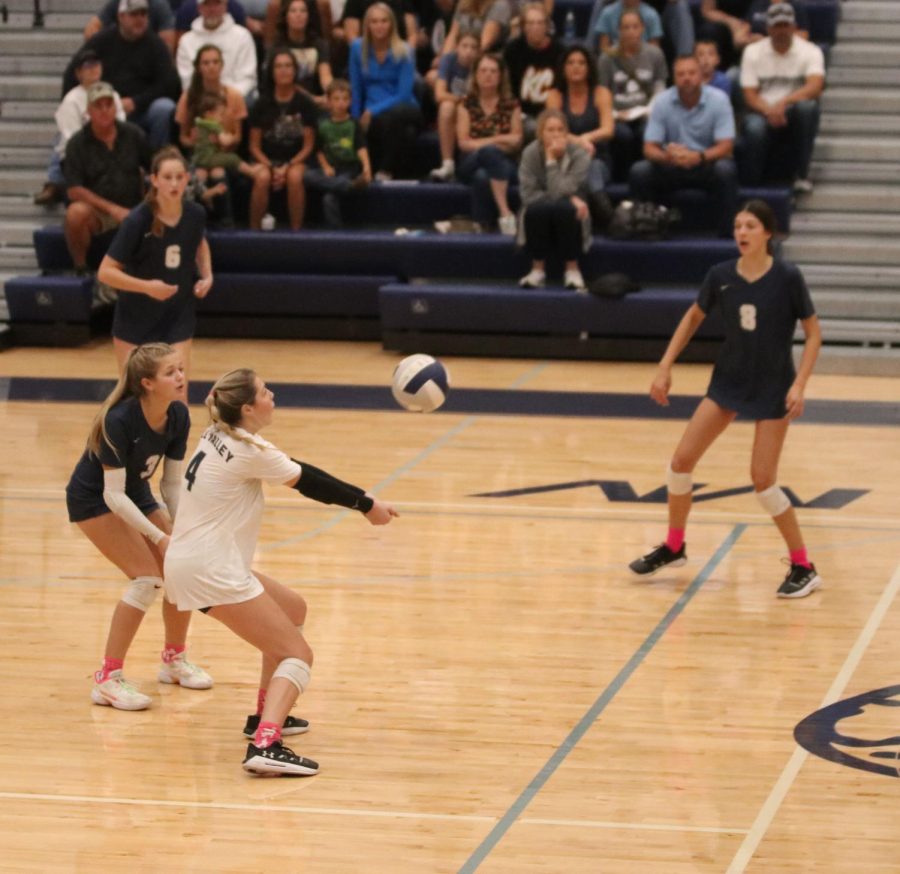 Arms in front of her senior Sidney Kacsir makes a pass to her setter.
