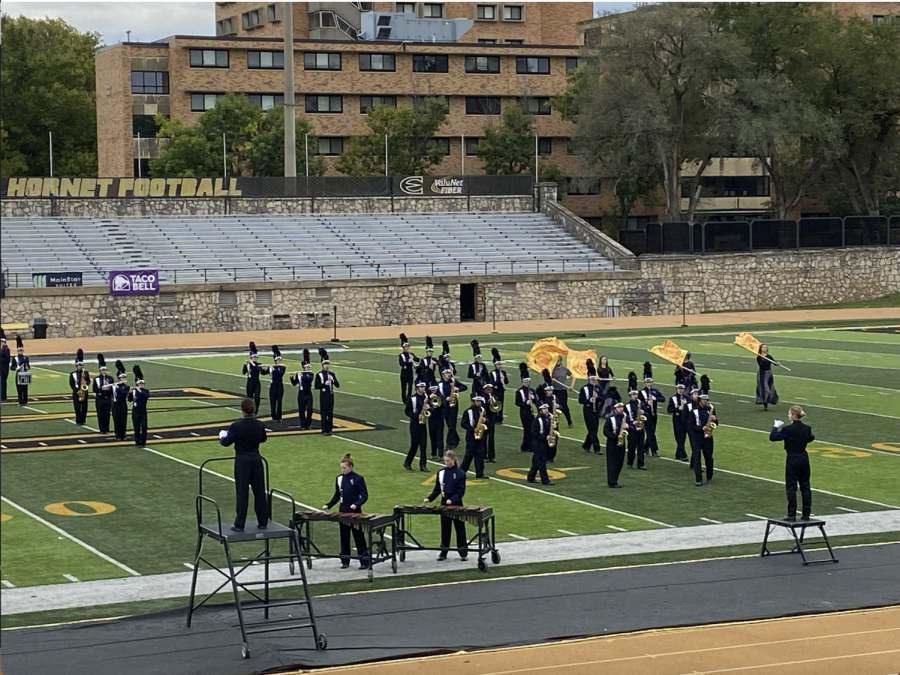Standing on the field at Welch Stadium at Emporia State University, the marching band performs its show Shockwave Wednesday, Oct. 5.