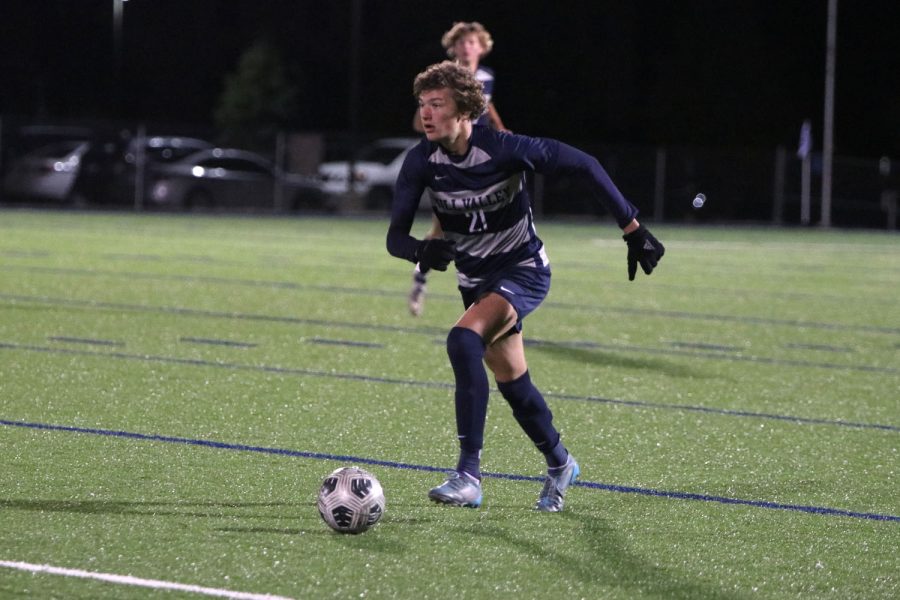 As he runs up the field, sophomore Nic Schrag keeps the ball in front of him.