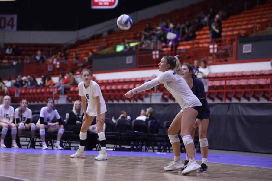 Arms out straight, senior Madeline Schnepf receives a ball from the opposing team. 