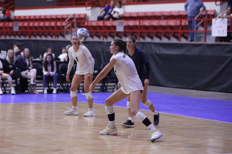 As she focuses on the ball, junior Kaitlyn Burke passes to her setter. 