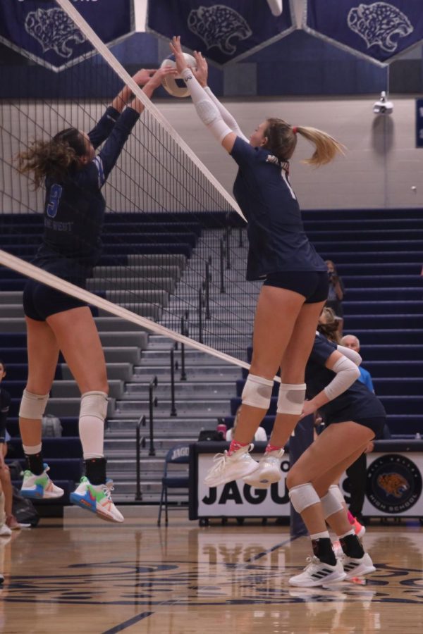 Hands on the ball, senior Madeline Schnepf blocks an attack from the other team.