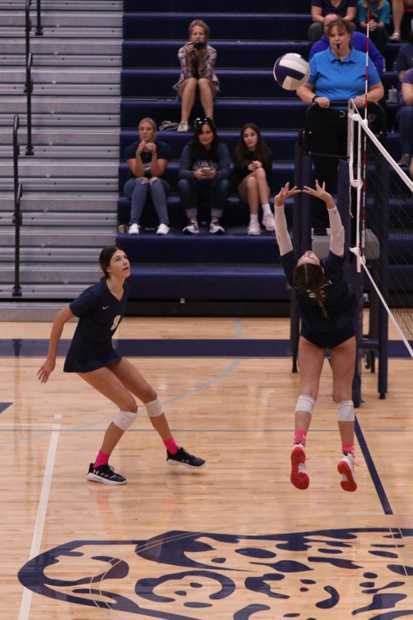 After she lets go of the ball, junior Ava Jones jumps off the ground to set to her right side hitter.