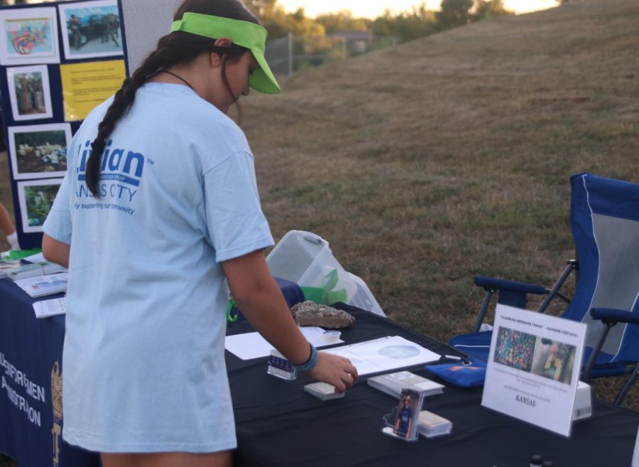 Senior Hayden Rider reads a pamphlet at the drug awareness event for Cooper Davis.