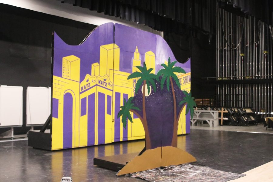 Having been painted, two sets for the upcoming musical Guys and Dolls are standing. They are a New York City inspired set and a desert-like starry night set.