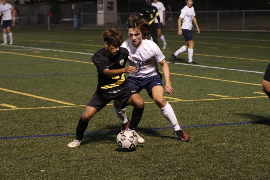 Junior Kael Drummond grabs the ball from his opponent against Shawnee Mission West. 