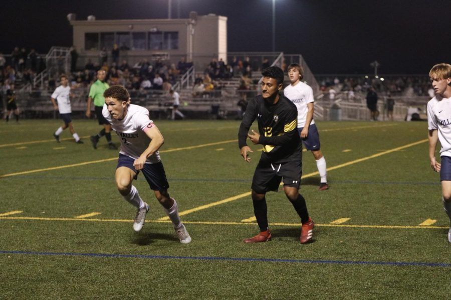 Senior Luke Shideler sprints to the ball, winning 3-1 against Shawnee Mission West.