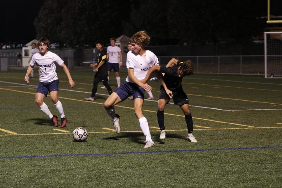 Senior Nicholas Hodson tries to get the ball from his opponent.
