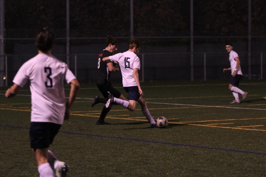 Dribbling downfield, senior Owen Prosser attempts to score a goal on Shawnee Mission Northwest. 