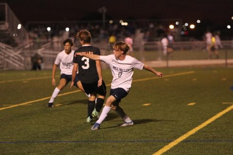 Arms out, senior Matt Morgan completes a pass kick to a teammate downfield. The boys soccer team beat SMNW 2-1 claiming the Sunflower League title for the second year in a row.