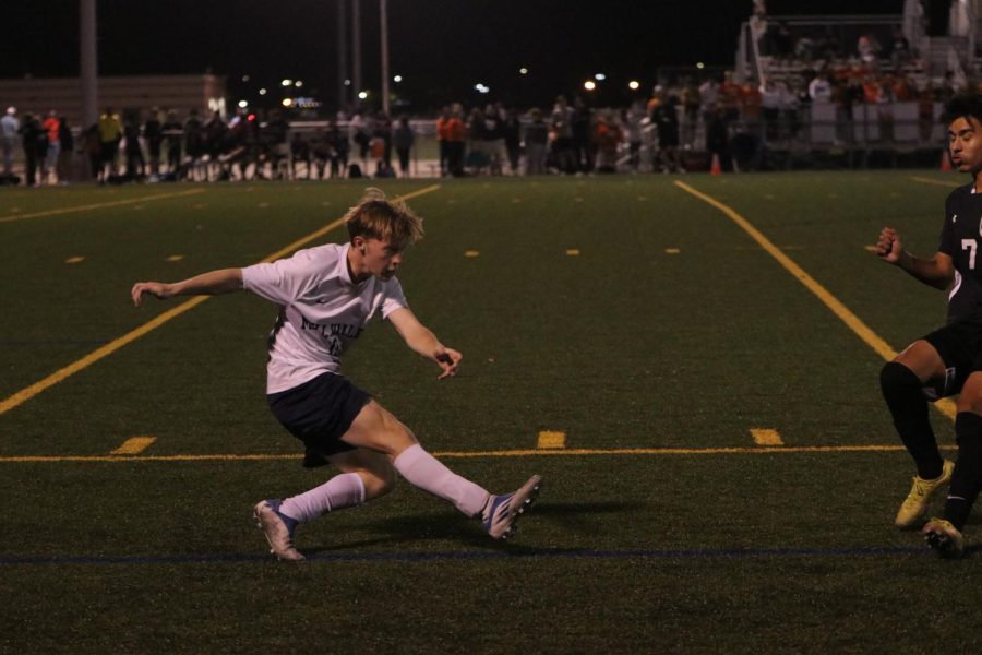 Dodging a midfielder from Shawnee Mission Northwest, senior Matt Morgan passes the ball to a teammate.