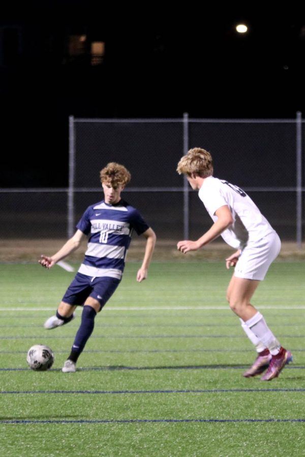 Going for the goal, senior Nico Pendleton attempts to make his way around an opponent.