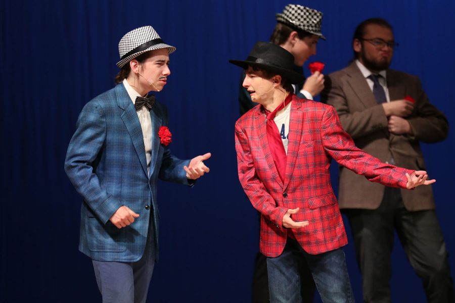 With concerned looks on their faces, senior Jameson Beran and freshman Drew Cormany discuss where to hold the crap game in “Guys and Dolls.”