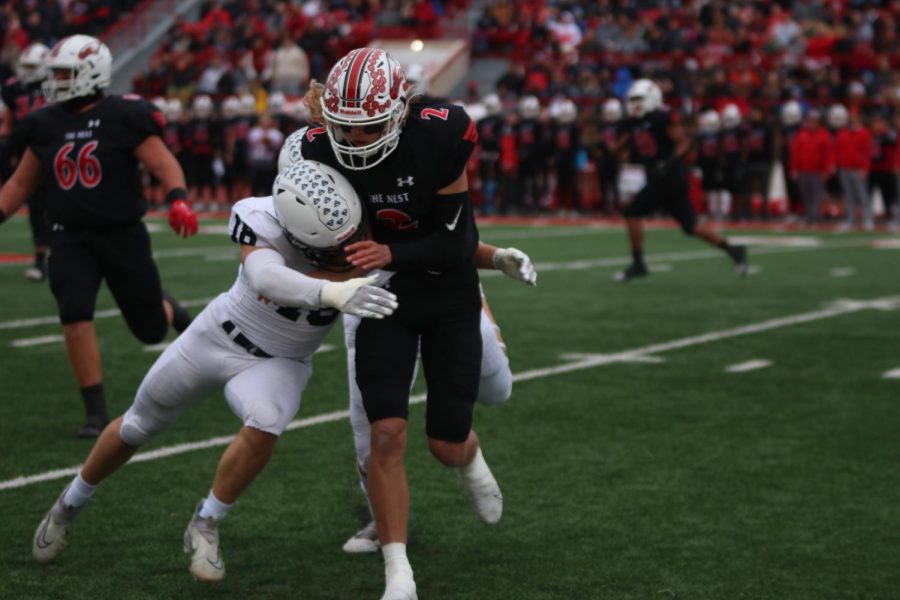 Senior Broc Worcester tackles Maize High's quarterback.