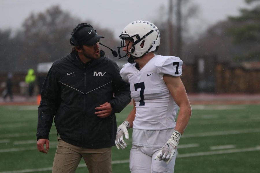 Offensive coach Reece Petty talks to senior Mikey Bergeron.