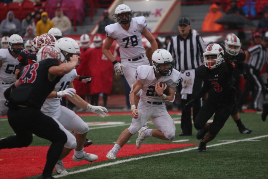 Junior Tristan Baker runs through the middle of the field.