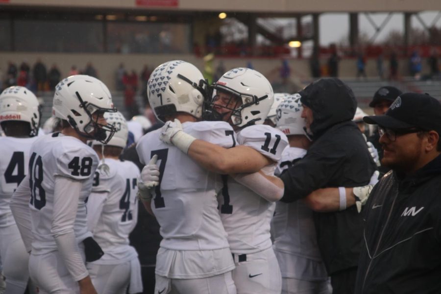 After a great win, seniors Mikey Bergeron and Mark Bauer exchange an emotional hug.