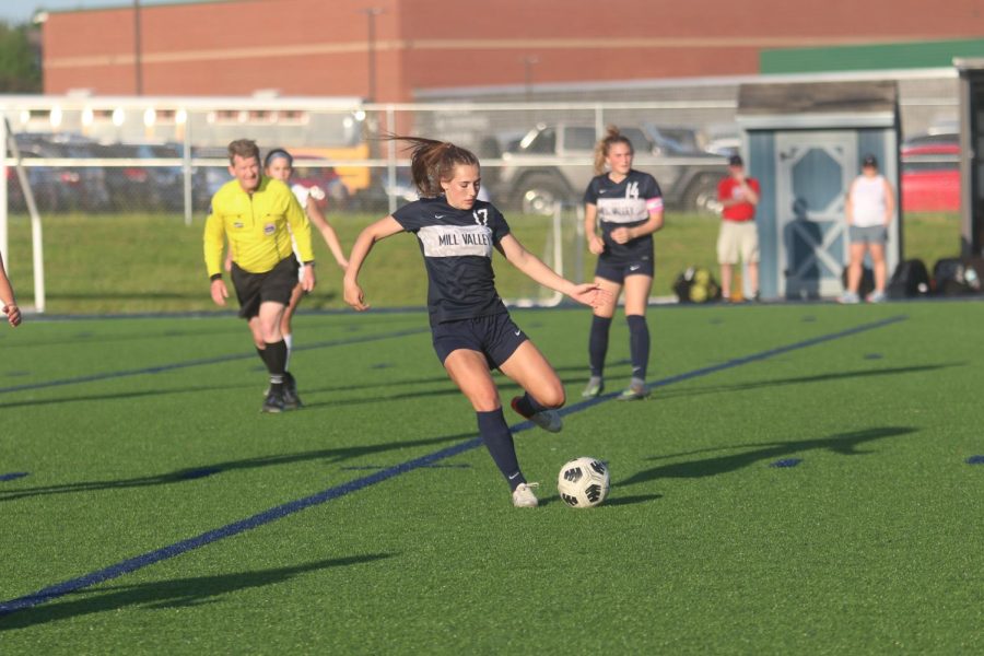 In the center field, senior Laney Reishus prepares to kick in the goal scoring the only point in girls soccer’s victory against Olathe North Thursday, May 12. 