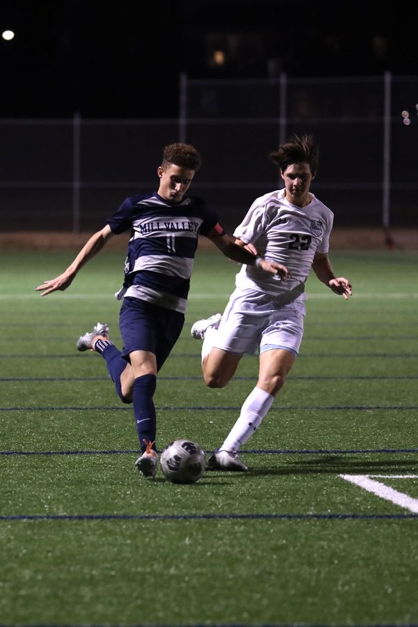 With his eyes on the ball, senior Dylan Ashford dribbles towards the goal. 
