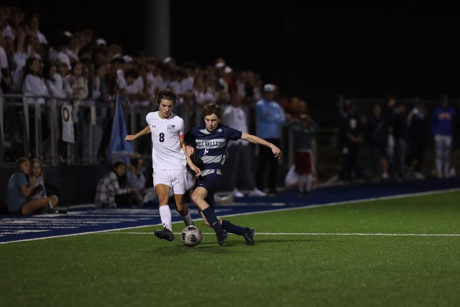 On the sideline, senior Toby Kornis fights for control of the ball.
