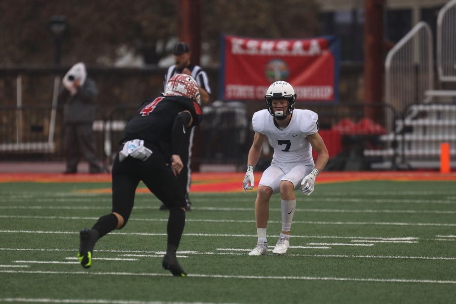 Senior Milkey Bergeron prepares to hold off the opposing teams wide receiver.