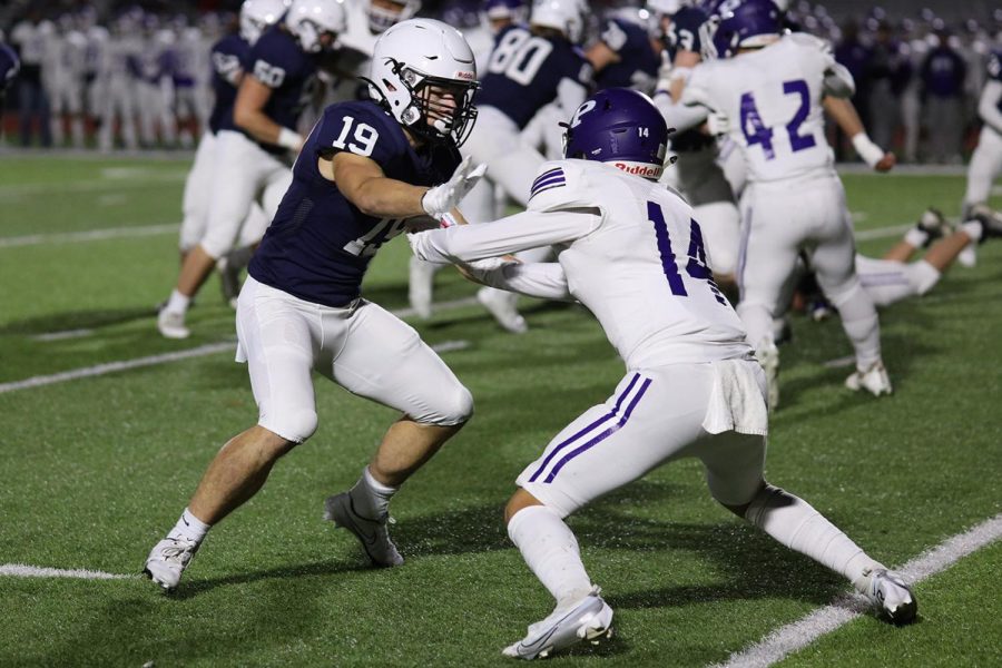 In an attempt to protect the running back, senior Hayes Miller holds off his opponent. 