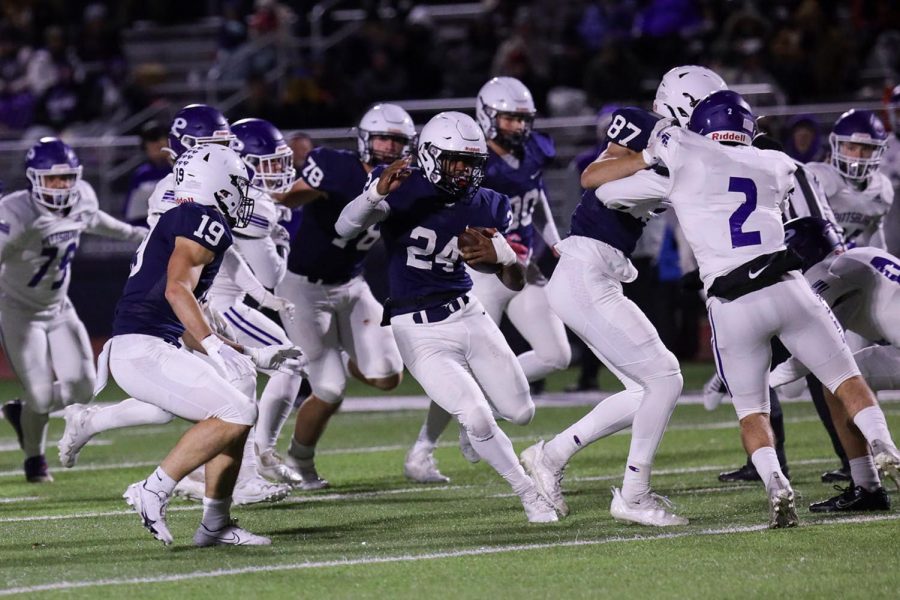 Running through the chaos, senior Amarian Graves moves the ball down the field. 