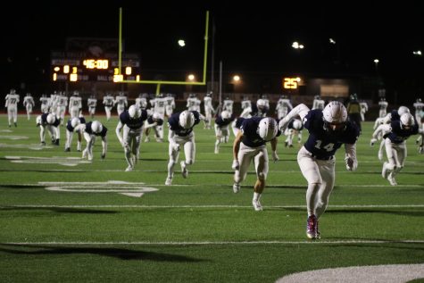 During pregame warmups, the football team sprints to the end zone before their 5A sub-state game against Blue Valley Southwest Friday, Nov. 18. 