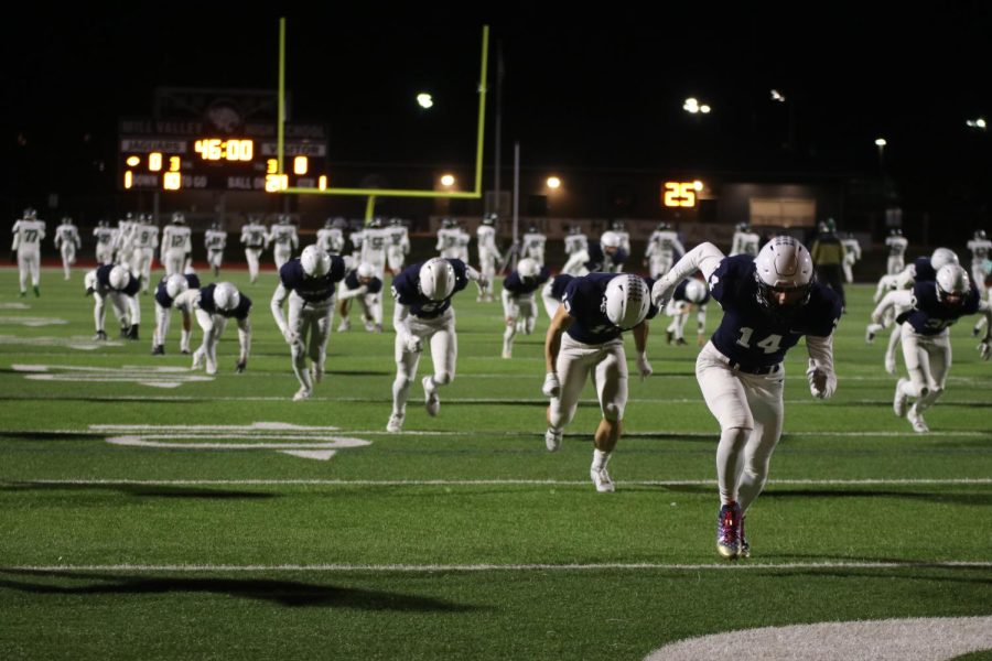 During pregame warmups, the football team sprints to the end zone before their 5A sub-state game against Blue Valley Southwest Friday, Nov. 18. 