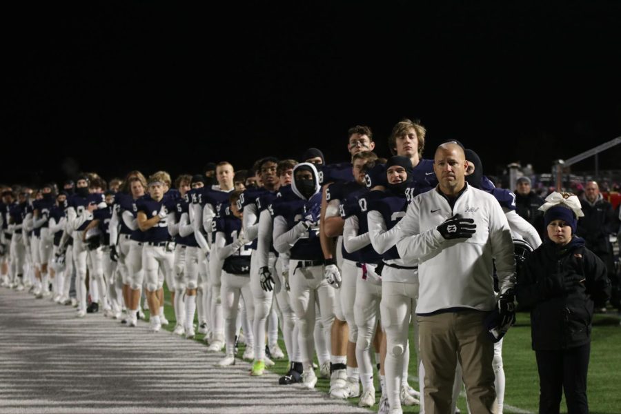 The team stands for the national anthem. 