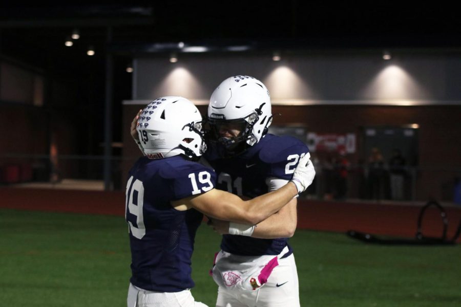 Celebrating with junior Tristan Baker after a touchdown is senior Hayes Miller.