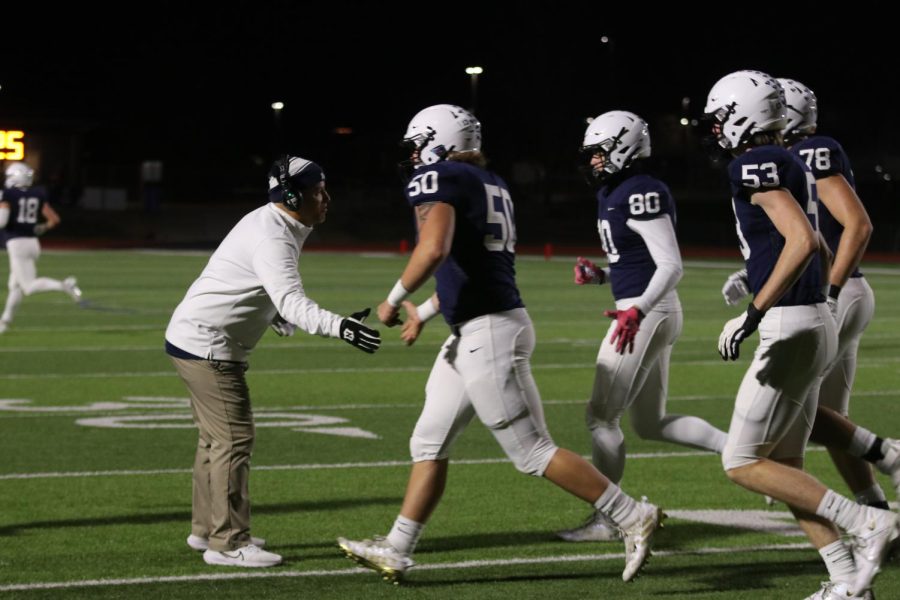Coach Joel Applebee gives the offensive line high-fives after a field goal.