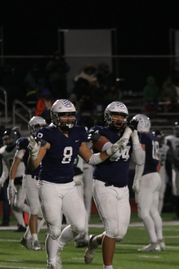 Celebrating after a defensive stop is junior Truman Griffith and senior Spencer Vaka.  